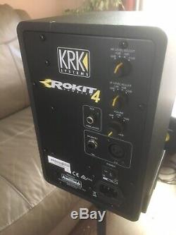 A Pair Of KRK Rokit Rp4 G3 Powered Studio Monitors In Black With Stands