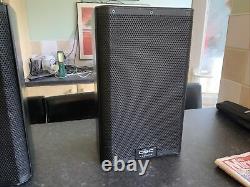 A Pair Of QSC K 8.2 Powered Speakers Inc Tote Bags And Mains leads